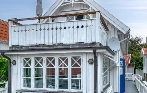 a house with a balcony on top of it at Awesome Home In Kyrkesund With Wifi in Kyrkesund