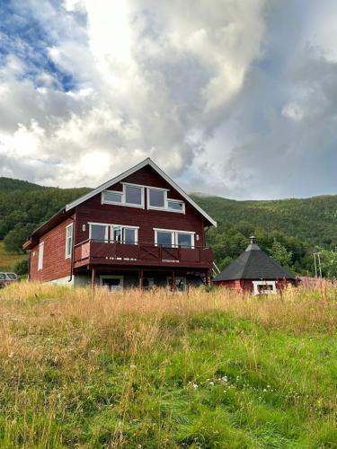 a house on top of a hill in a field at 3ART recreation in Tromsø