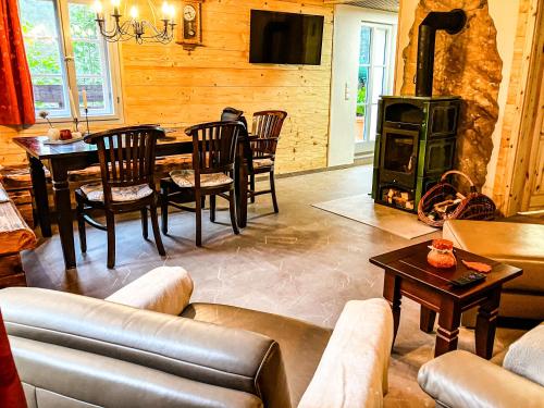 a living room with a couch and a wood stove at LIETHE 13 - Ferienhaus am Malerweg in Kurort Gohrisch