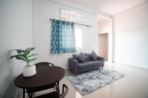 a living room with a couch and a table at Betong 939Homestay in Betong