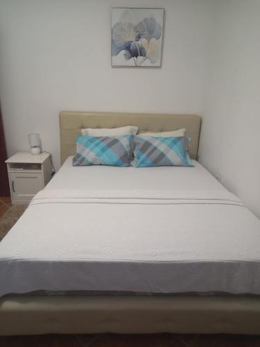 1 cama con colchón blanco y una foto en la pared en Perovic 23, en Rafailovici