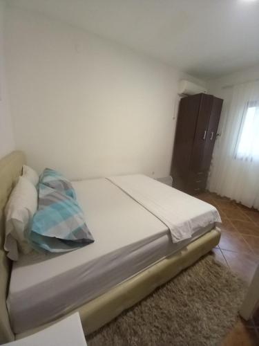 a bedroom with a bed with a pillow on it at Perovic 23 in Rafailovici