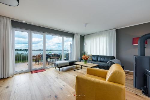 a living room with a couch and a table at Ferienhaus Nordlicht Olpenitz in Olpenitz
