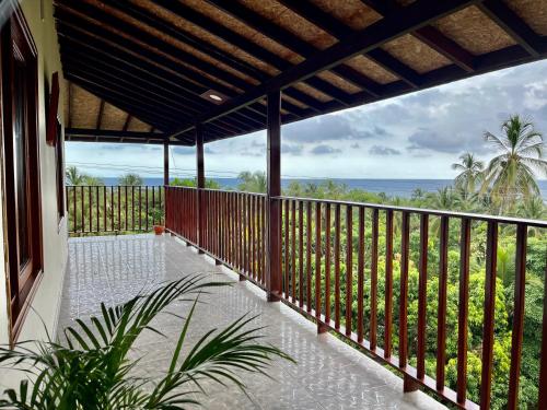 a balcony with a view of the ocean at HOSTAL MIRADOR TAYRONA in Santa Marta