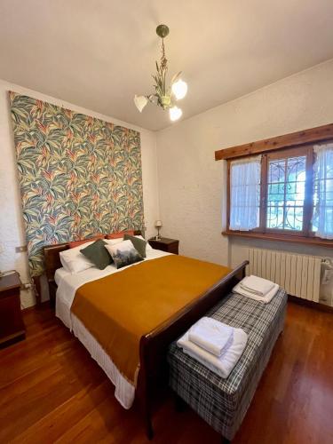 a bedroom with a large bed and a window at Villa La Collina in Giais