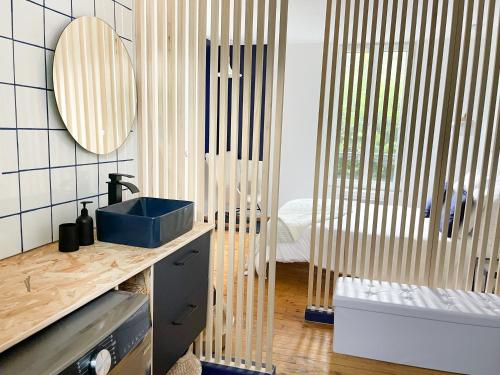 a bathroom with a sink and a mirror on the wall at Appartement Rose velours in Le Mont-Dore