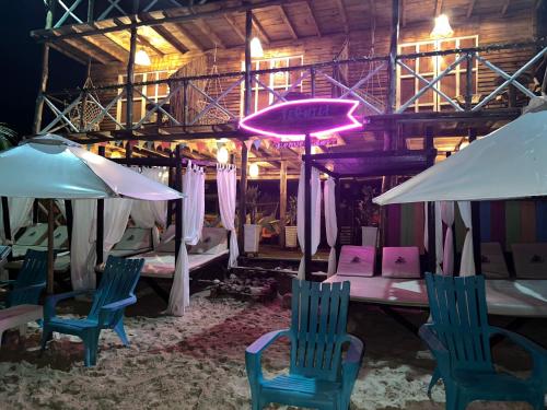 a room with chairs and a table and umbrellas at Tequila SunBeach Baru Eco-Hotel in Baru