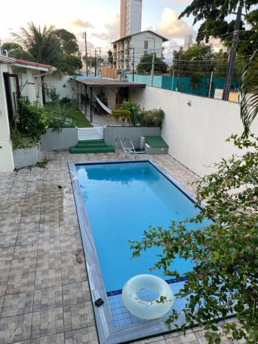 a swimming pool in the backyard of a house at Flat ACM in Natal