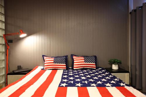 a bedroom with an american flag bed with two pillows at RestCipe' in Chiang Mai