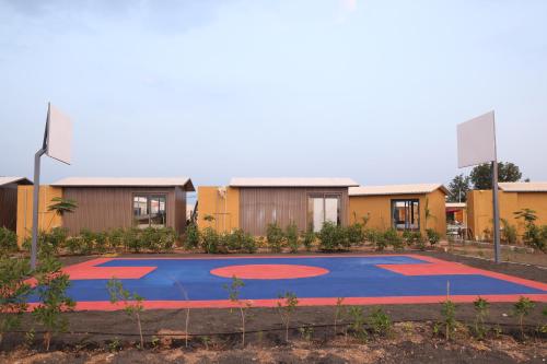a basketball court in front of a building at SKD RESORT AND CLUB in Barvāla