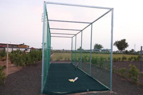 a person laying on a batting cage in a batting cage at SKD RESORT AND CLUB in Barvāla