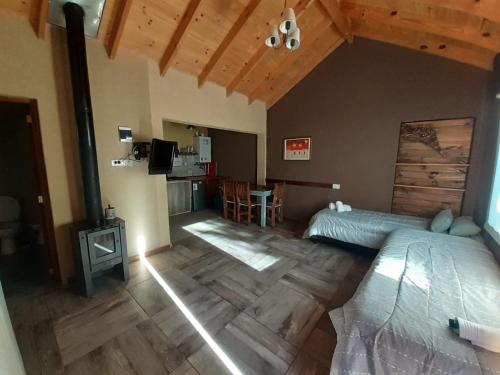 a bedroom with a bed and a table in it at cabañas la arqueria candelaria in Villa Meliquina