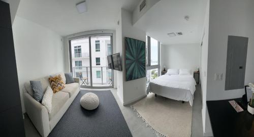 a living room with a couch and a bed at Downtown Miami Hotel in Miami