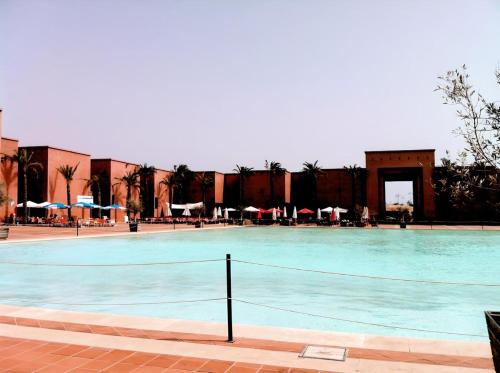 a large swimming pool with chairs and umbrellas at Cozy Pool & Golf House at Condado de Alhama 