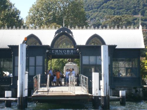 a group of people sitting on a dock on the water at Villa Cernobbio in Cernobbio