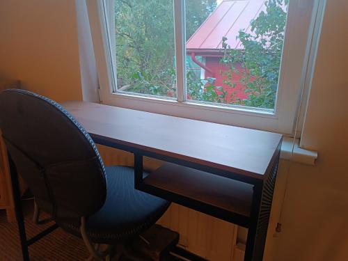 a desk with a chair in front of a window at Small apartment in historical area near the city in Tallinn