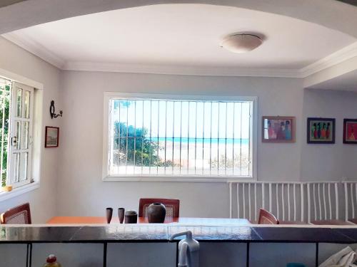 a dining room with a table and a window at Casa na praia de Setiba com panorama fantástico in Guarapari