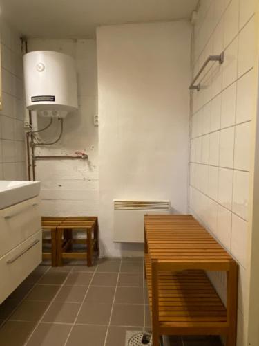 a kitchen with a sink and a table in it at Apartment Brevik in Brevik