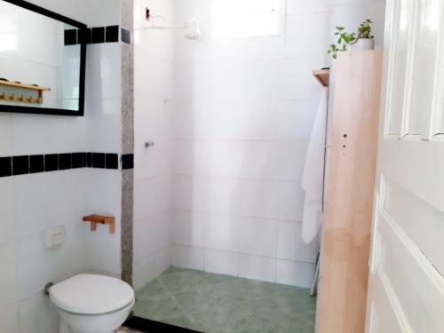 a bathroom with a toilet and a sink at Casa na praia de Setiba com panorama fantástico in Guarapari