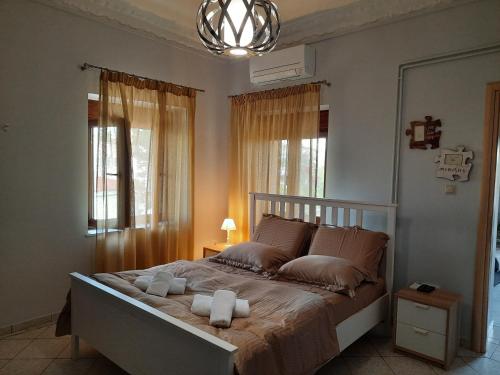 a bedroom with a bed with two towels on it at Marathon VS LUXURY VILLA in Grammatiko