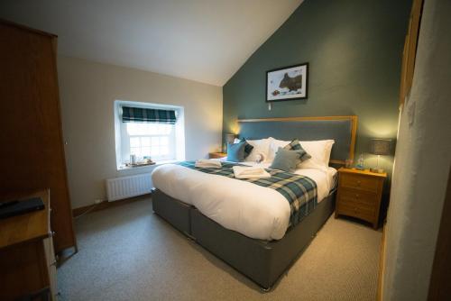 a bedroom with a bed and a window at The Mardale Inn in Penrith