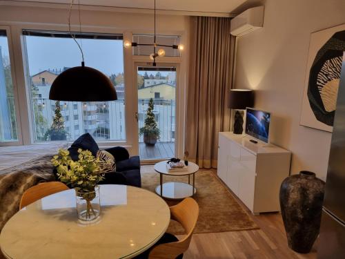 uma sala de estar com uma mesa e um sofá em Premier Residences Helsinki em Helsinque