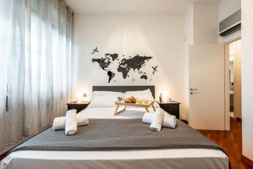 a bedroom with a large bed with a world map on the wall at Duomo 5 minutes - Elegant with Wifi and Netflix in Milan