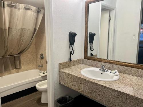 a bathroom with a sink and a phone at Extend -a -Suites Mesa in Mesa