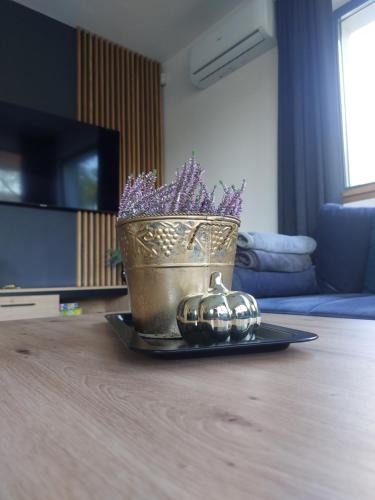a vase with purple flowers and a pumpkin on a table at Lawendowa Stodoła in AdamÃ³w