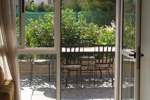 an open door to a patio with a table and chairs at Residence tafoult imi ouadar taghazout in Imi Ouaddar