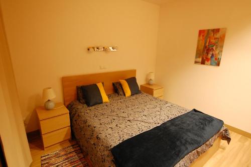 a bedroom with a bed and two night stands at Air-Conditioned, Remarkably Beautiful Apartment, Fibre Wi-Fi, Pool in Arona