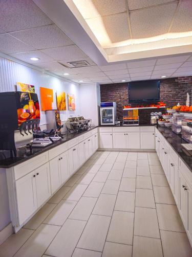 a large kitchen with white cabinets and a counter top at Comfort Inn Hyannis - Cape Cod in Hyannis