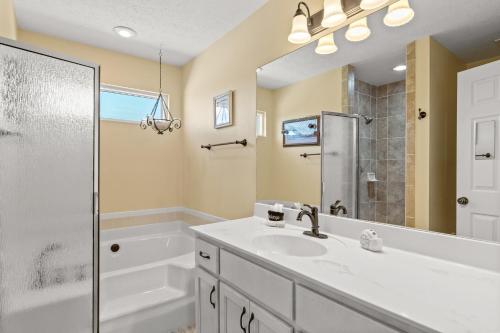 a bathroom with a sink and a shower at 21720 Front Beach Rd - Pelican's Nest in Panama City