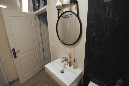 a bathroom with a sink and a mirror on the wall at Air-Conditioned, Remarkably Beautiful Apartment, Fibre Wi-Fi, Pool in Arona