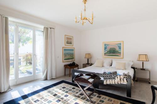 a bedroom with a bed and a chandelier at Villa Ani in Ascona