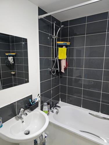 a bathroom with a sink and a tub and a mirror at Bridgepay Double Room in Kenton