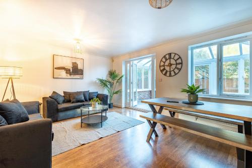 a living room with a couch and a table at 5 Bed House Heathrow Egham Virginia Water Sleeps 7 or Up To 8 If Sharing Beds, Mid To Long Term Bookings Welcome in Egham