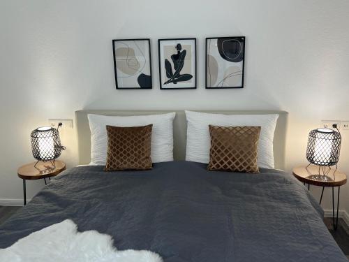 バート・ローテンフェルデにあるModerne 2 Zimmer Wohnung Salinaのベッドルーム1室(壁に3枚の写真が飾られたベッド1台付)