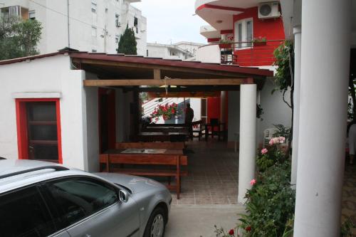a car parked in front of a house with a patio at Lukic Apartmani in Bar