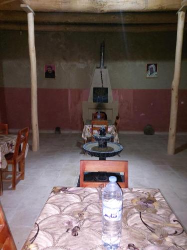 a bottle of water sitting on a table in a room at KASBAH Atlas-Aberdouz in Aït Hattab