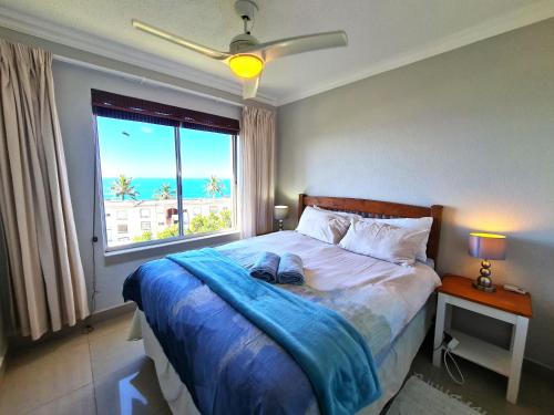 a bedroom with a bed with a view of the ocean at Laguna La Crete L in Margate