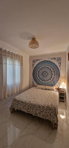 a bedroom with a bed with a blue and white wall at Sweet flat in Tortosa in Tortosa