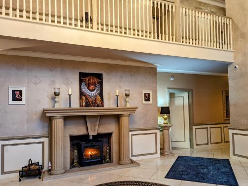 a living room with a fireplace and a staircase at FINN VILLAGE - Loch Lomond Villa B&B with a Hot Tub in Glasgow