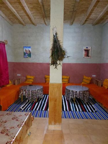 a room with couches and tables in a room at KASBAH Atlas-Aberdouz in Aït Hattab