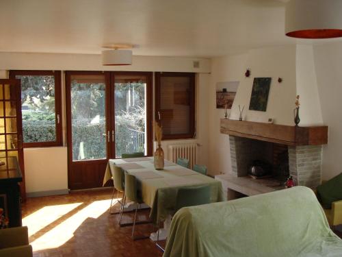 a living room with a table and a fireplace at la coccinelle in Conflans-Sainte-Honorine