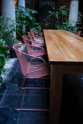 a group of chairs sitting at a wooden table at Casa Antonieta in Oaxaca City