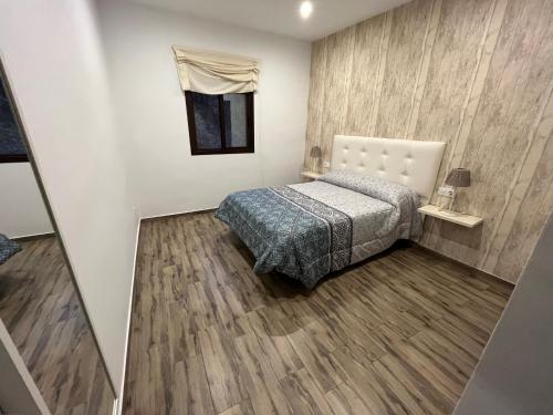 Ένα ή περισσότερα κρεβάτια σε δωμάτιο στο Casa rural Huertas de Ubrique