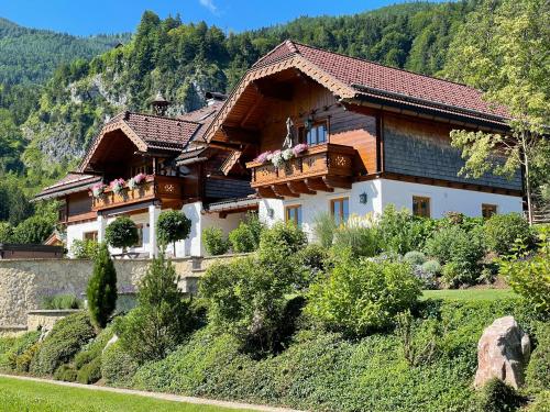 a large house on top of a hill at Ferienwohnung Schossleitner - der Wohlfühl-Ansitz am Wolfgangsee mit Weitblick in Sankt Gilgen