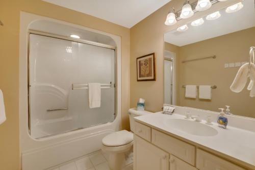 a bathroom with a sink and a toilet and a mirror at 604 Disciples Village Condo in Boyne Falls