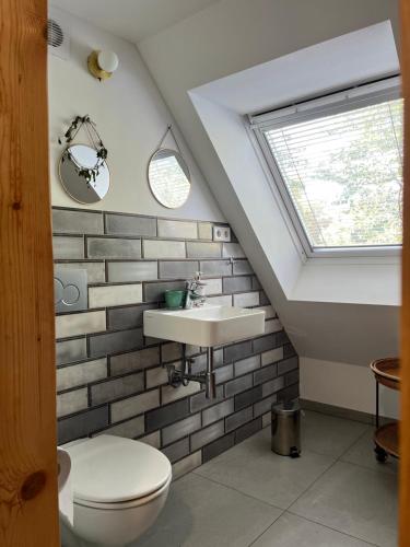 a bathroom with a sink and a toilet at Dom Kopaczówka - sauna, home spa in Wünschelburg